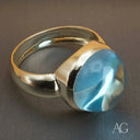 Elegant sterling silver cabochon blue topaz ring with oval gemstone