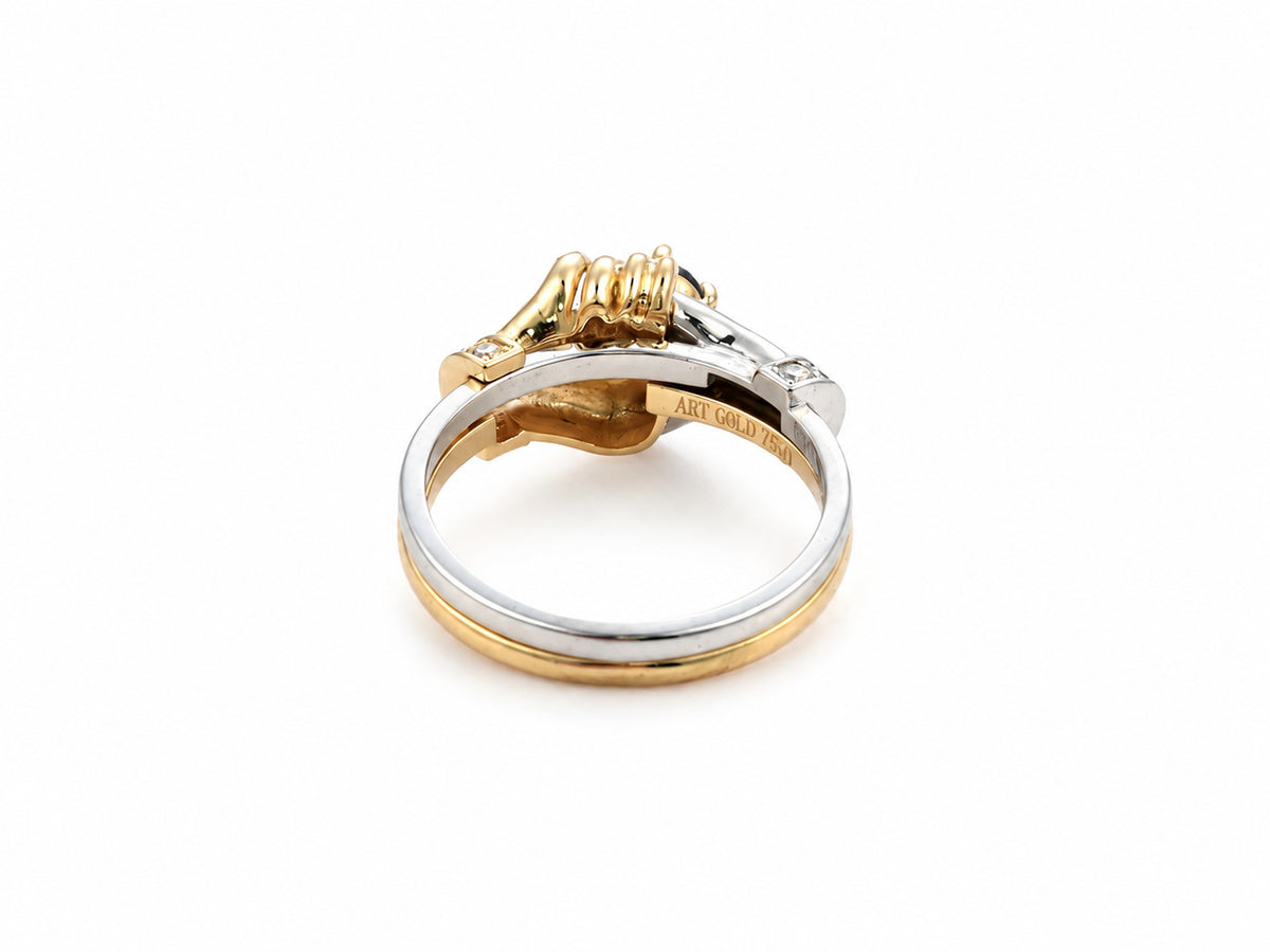 Side view of two-tone gold ring highlighting diamond accents and sculpted hand details