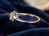 Side view of white gold three-stone diamond ring showing band profile