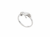 Side view of yellow gold ring with sculpted clasped hands, sapphire and diamond accents