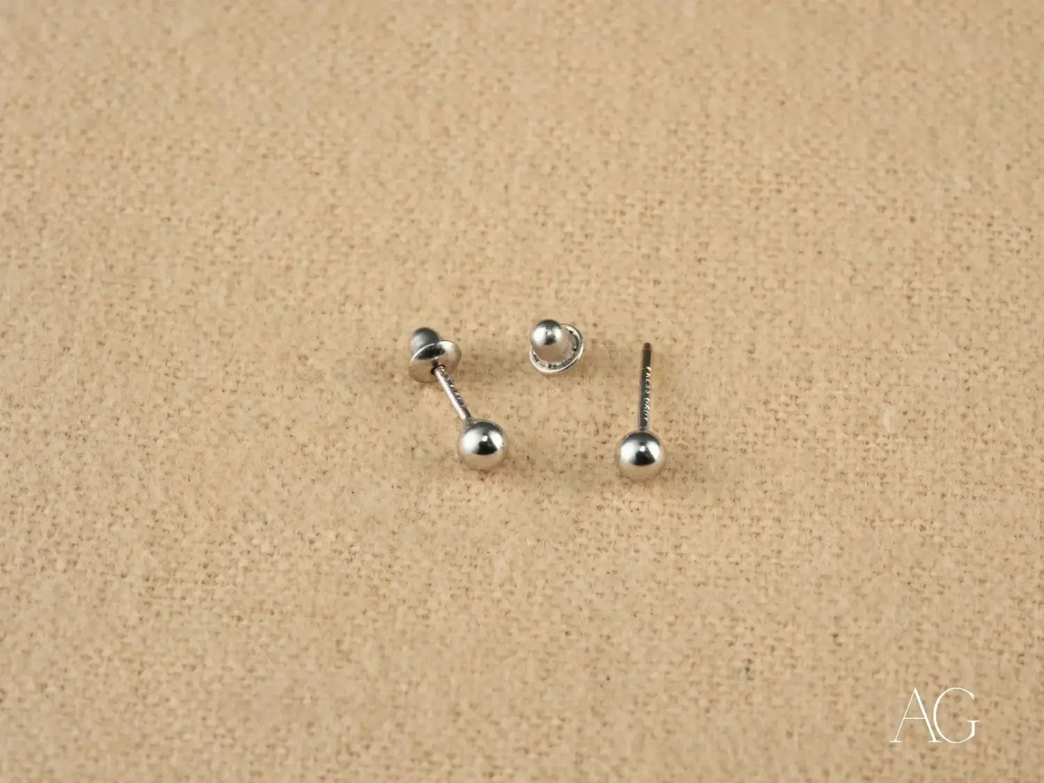 silver ball stud earrings with a minimalist design complement art gold jewelry styles influenced by massachusetts designer rinaldo borges in community fashion trends