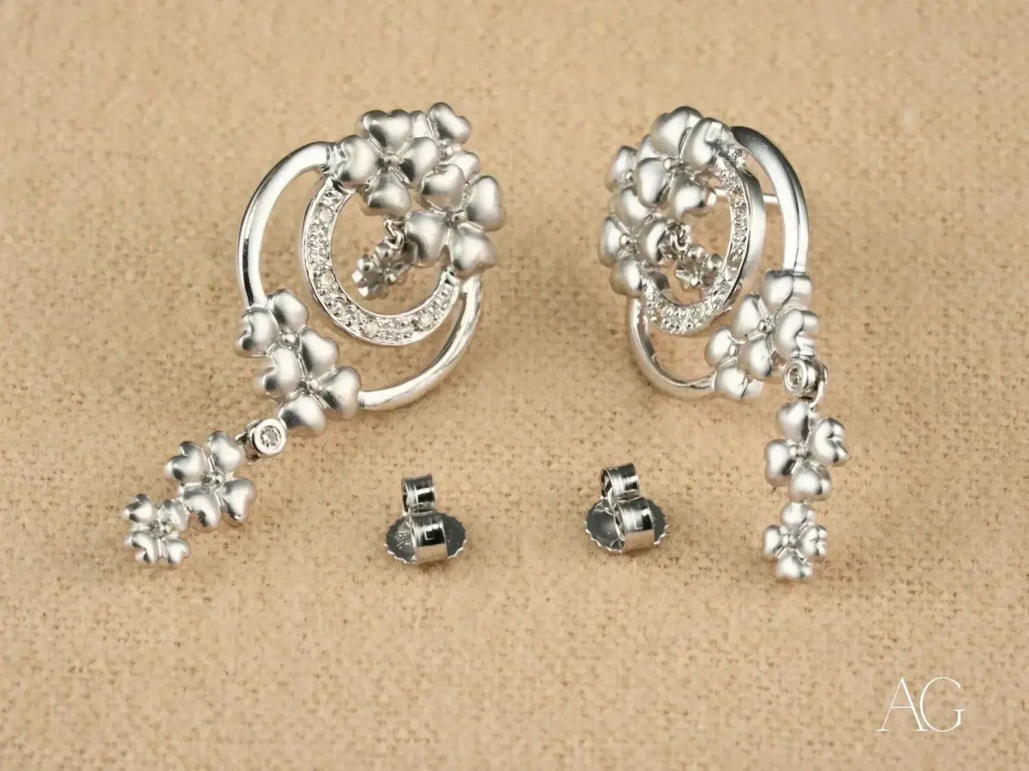 A sparkling pear-shaped diamond ring set in platinum with round diamonds showcasing fine jewelry trends.
