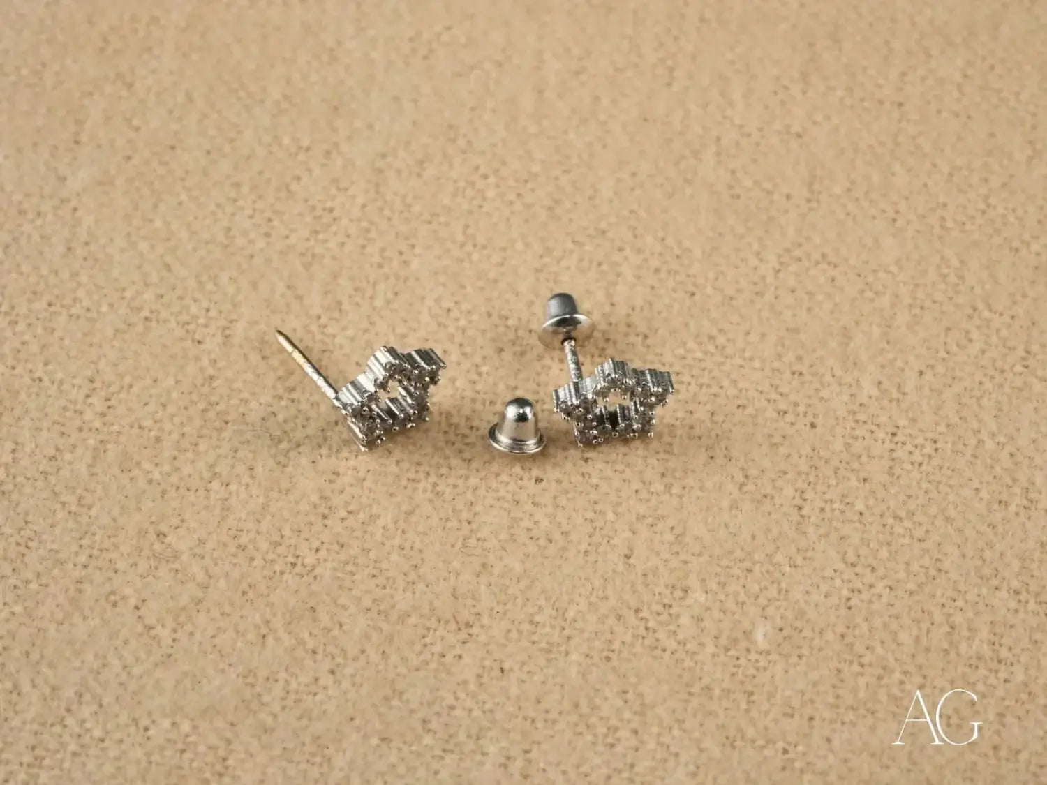 Silver stud earrings with geometric crystal design evoking Hope Diamond mystique