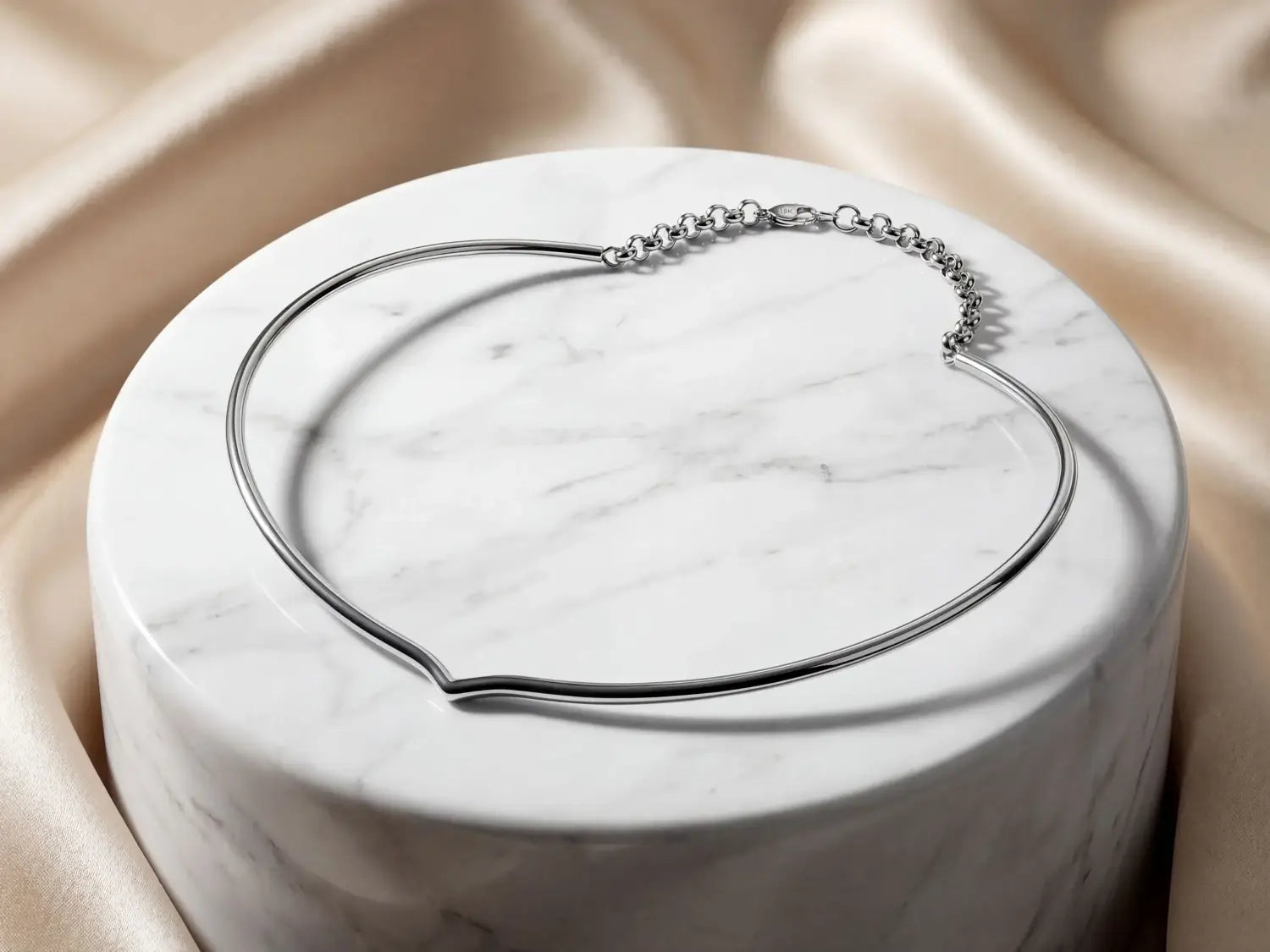 a silver-toned minimalist choker necklace featuring a sleek continuous band and delicate chain clasp complementing unique gold jewelry and fine jewelry collections including 18k gold designs