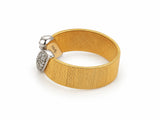 Alternate three-quarter view of the two-tone ring from the opposite side, showing the interior of the band with a visible hallmark.
