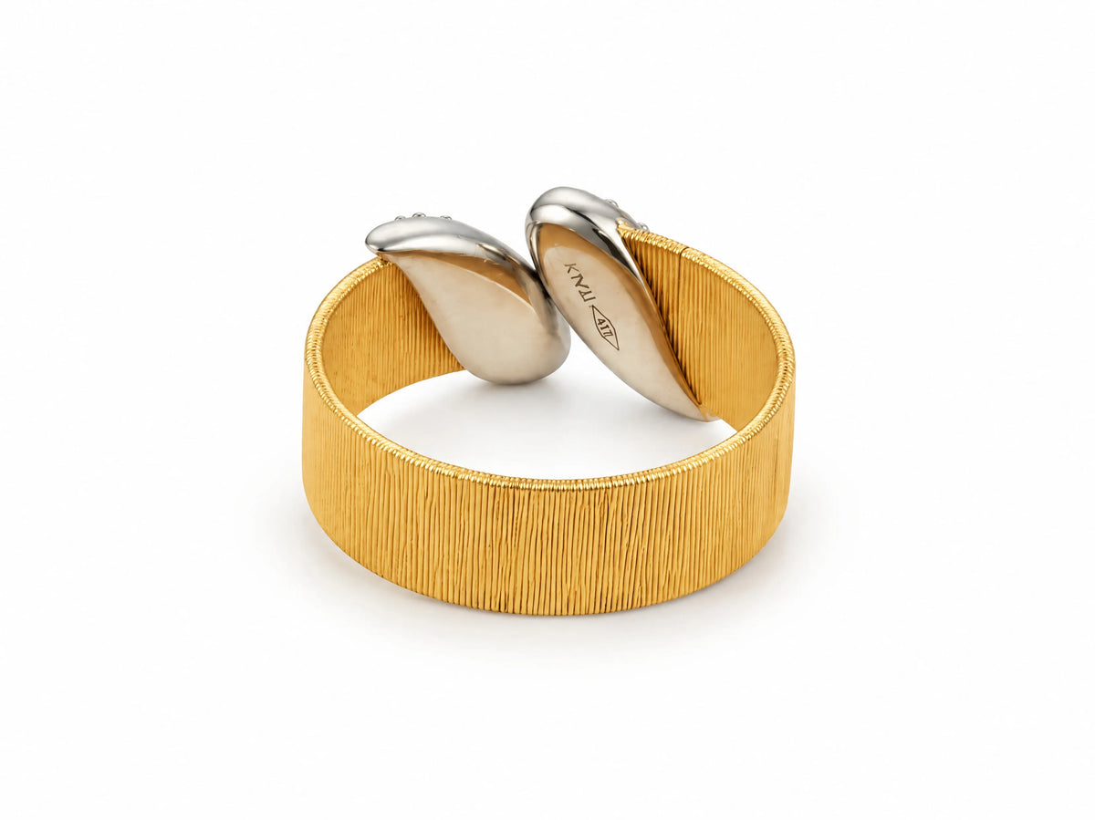 Back view of the two-tone ring showing the smooth reverse of the white gold leaves and the inner band.