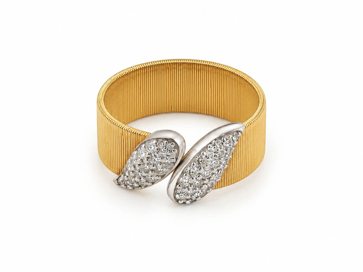 Top view of the two-tone wide band ring showing the two crossed white gold leaves set with diamonds.
