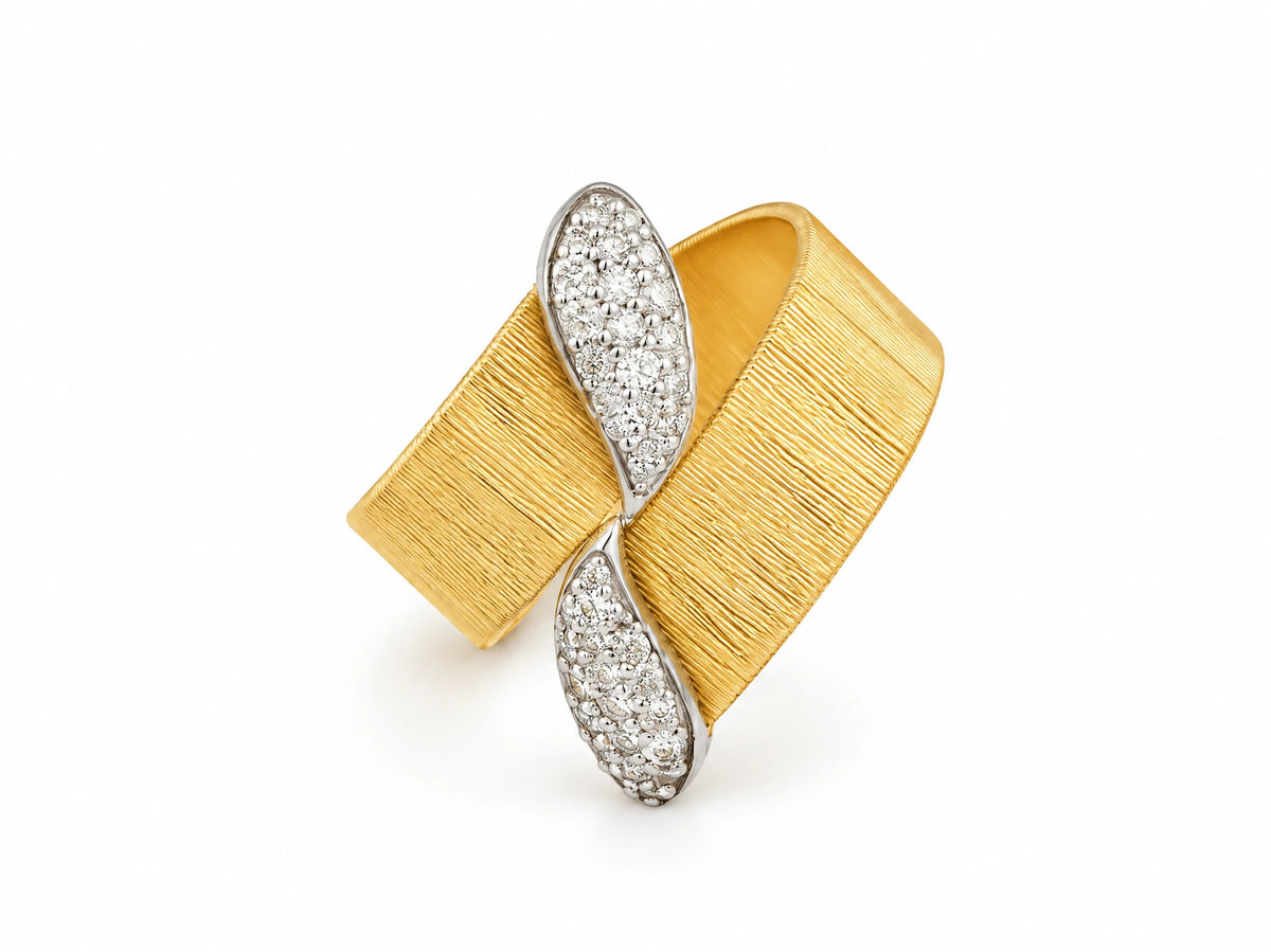 Three-quarter view of a two-tone wide band ring; a white gold ribbon set with pavé diamonds crosses the brushed yellow gold band, on a white background.