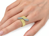 Second hand-worn view of the two-tone ring, three-quarter angle, showing the white gold ribbon set with pavé diamonds.