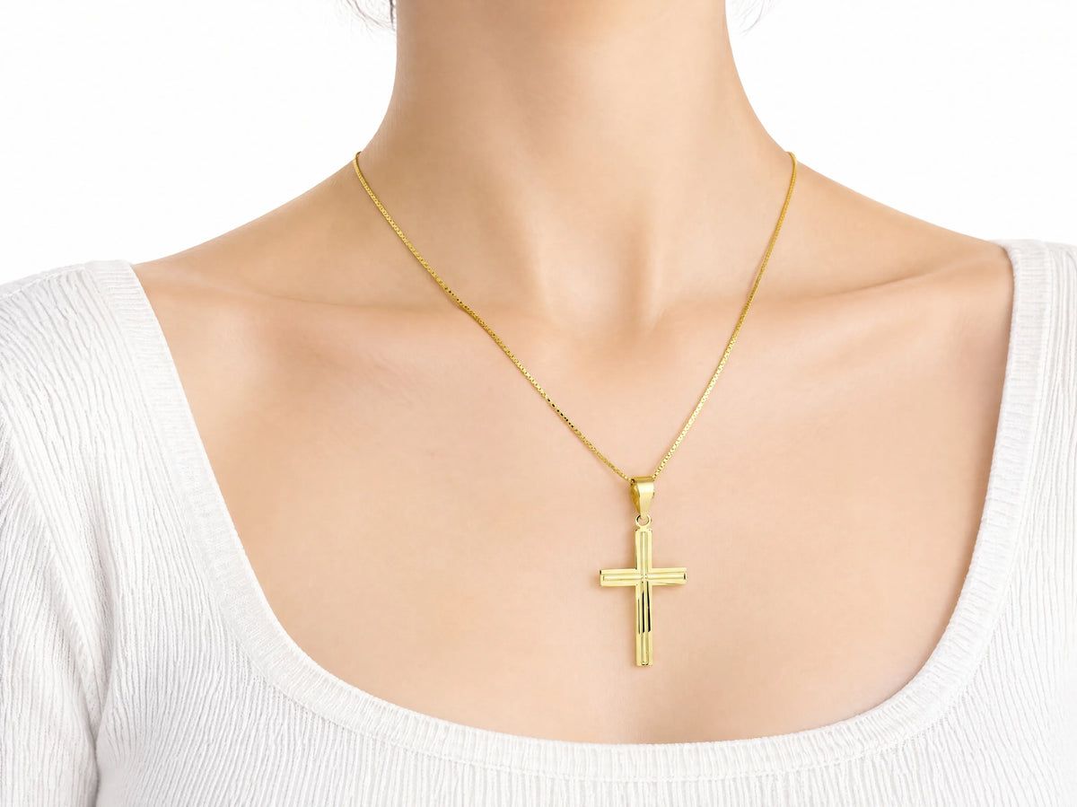 18K Gold Fluted Cross Pendant, L size, worn on a person showing the scale of the 20 x 30 mm cross