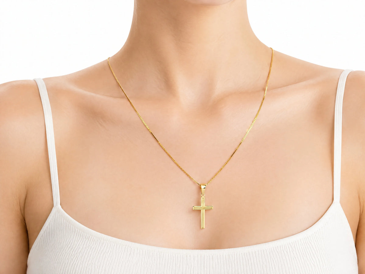 18K Gold Fluted Cross Pendant, S size, worn on a person showing the scale of the 14 x 20 mm cross