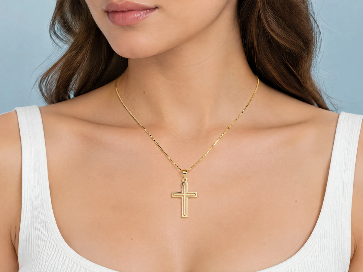 Openwork cross pendant M size worn for scale, 17 x 25 mm.
