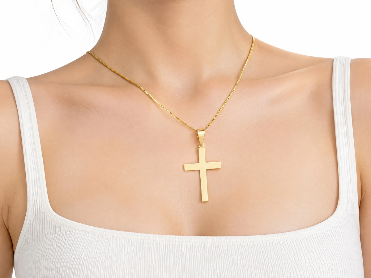Smooth cross pendant L size worn for scale, 20 x 30 mm.