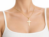 Smooth cross pendant M size worn for scale, 17 x 25 mm.