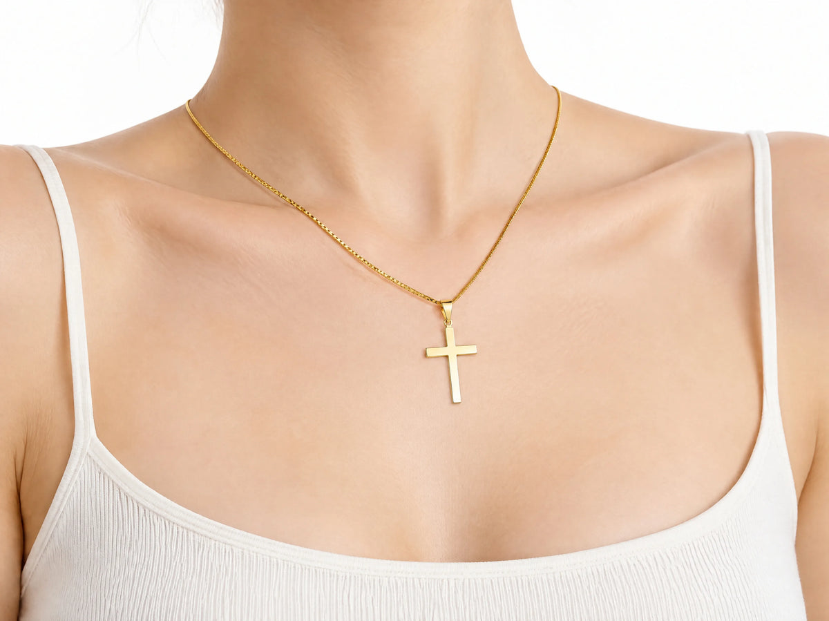 Smooth cross pendant S size worn for scale, 14 x 20 mm.