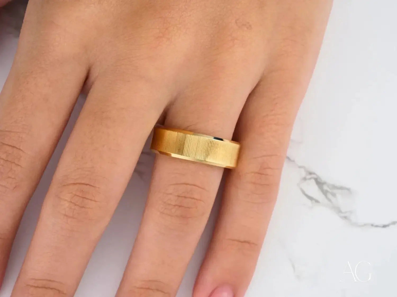 a collection of intricate gold jewelry including 18k gold rings and pendants featuring faces and cacti designs