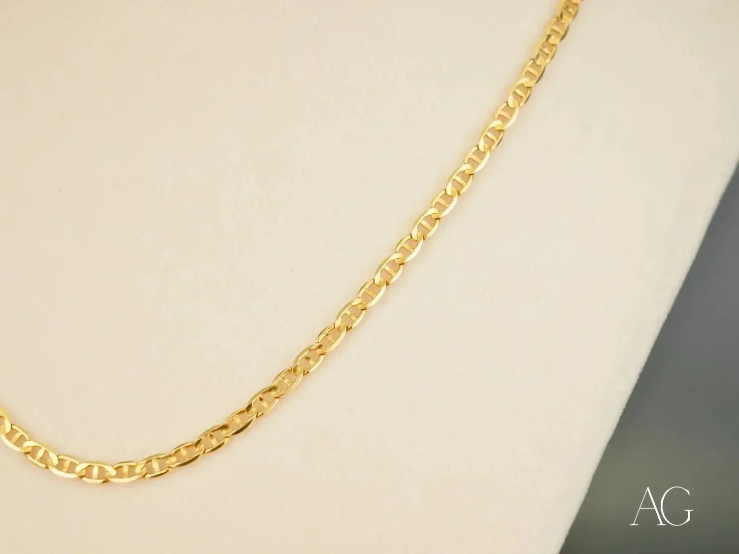Sleek gold-toned figaro chain in art gold jewelry collection display