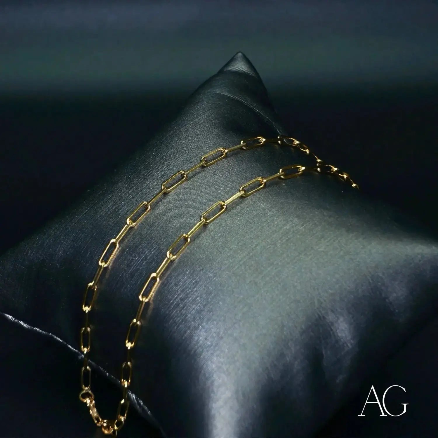 Sleek Buccellati art gold jewelry necklace on satin pillow