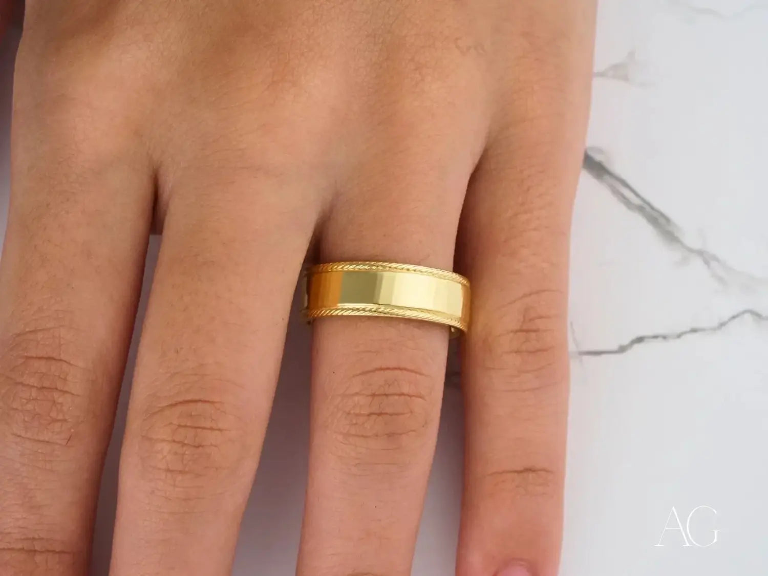 Gold bangle with intricate floral and ribbed design featured in heirloom gold and diamond jewelry care tips at Everett jewelry store.