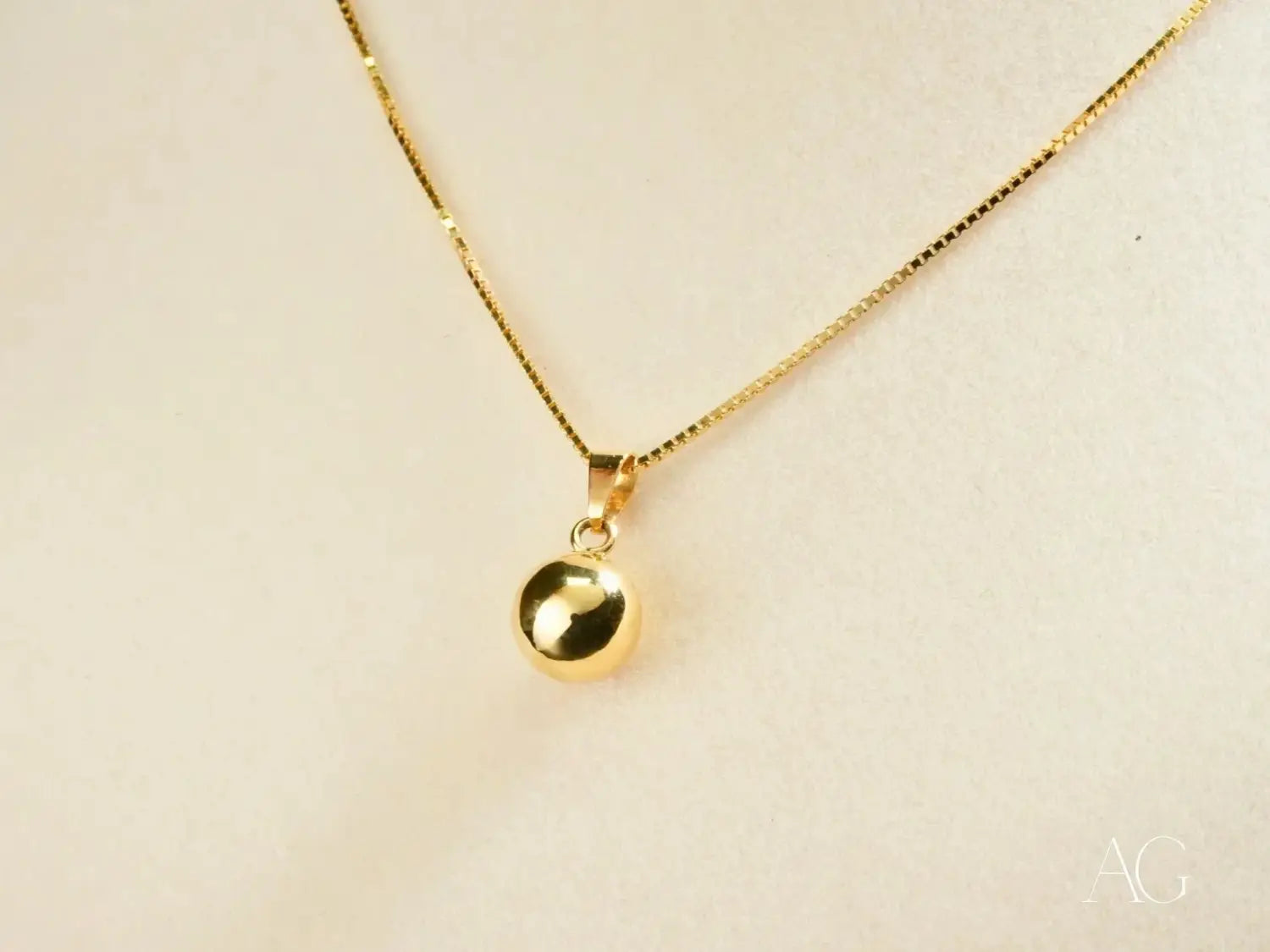Stunning 18k gold ball pendant on matching chain, rivaling famous diamonds
