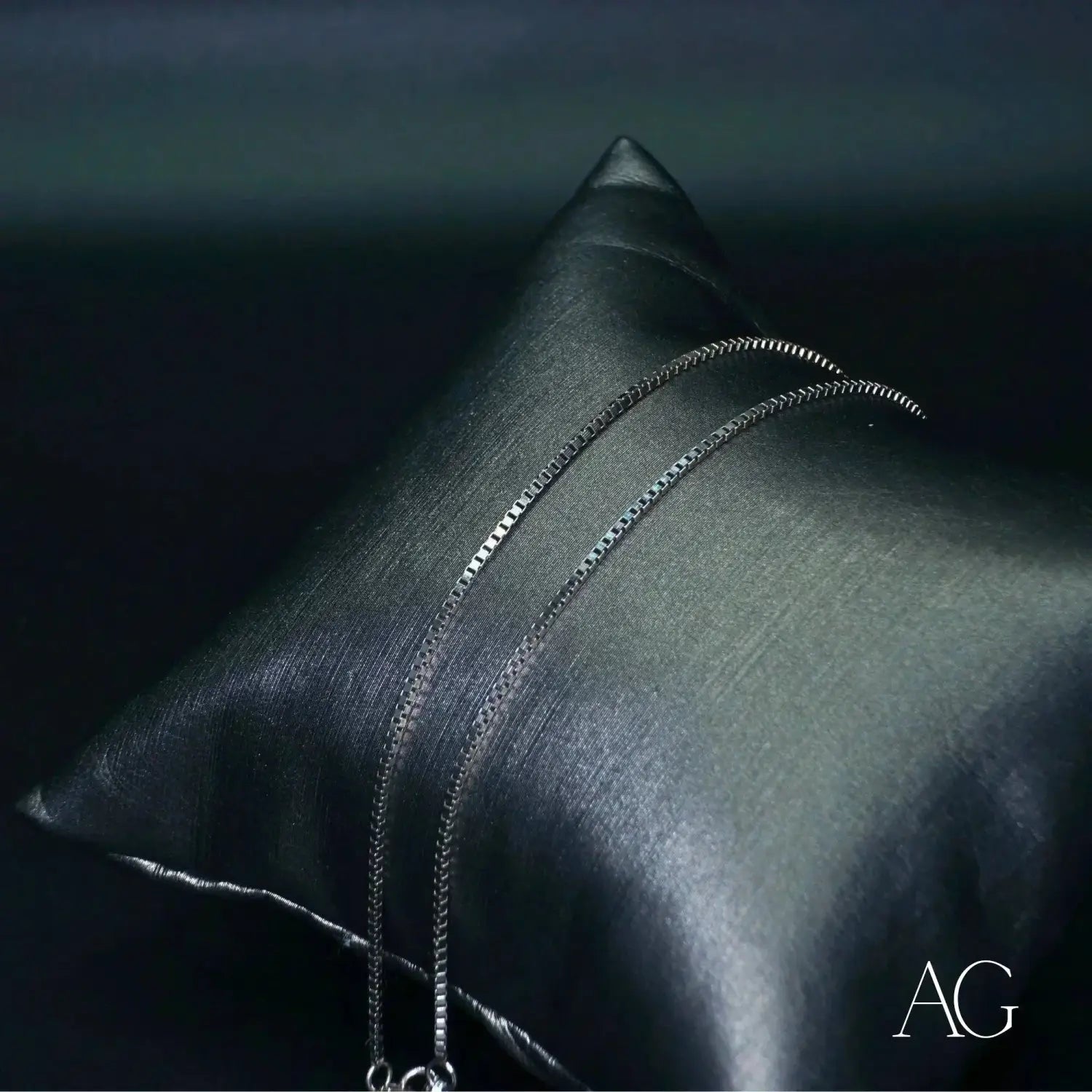 Stunning 18k gold box chain necklace on satin pillow