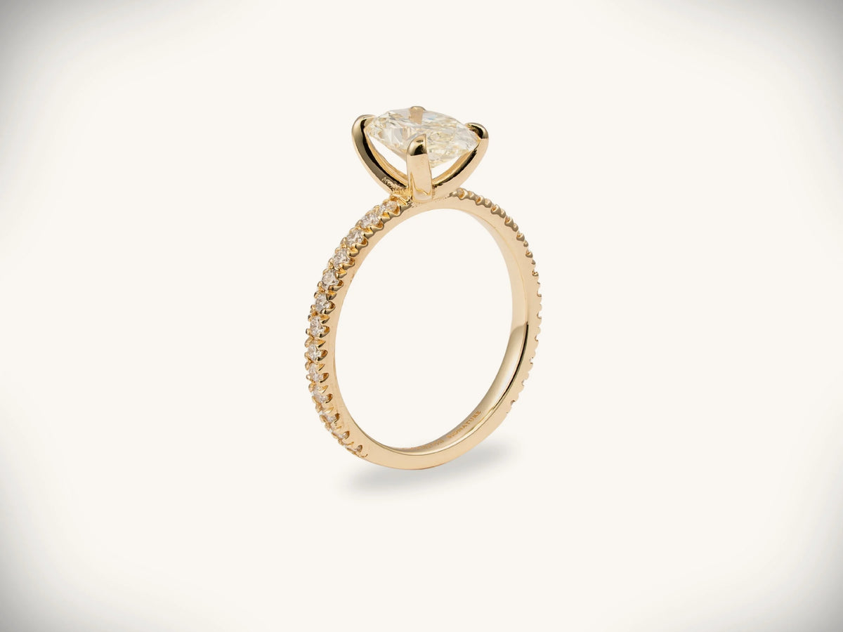 Soleil Pavé 18k gold oval diamond engagement ring with cushion-cut center stone