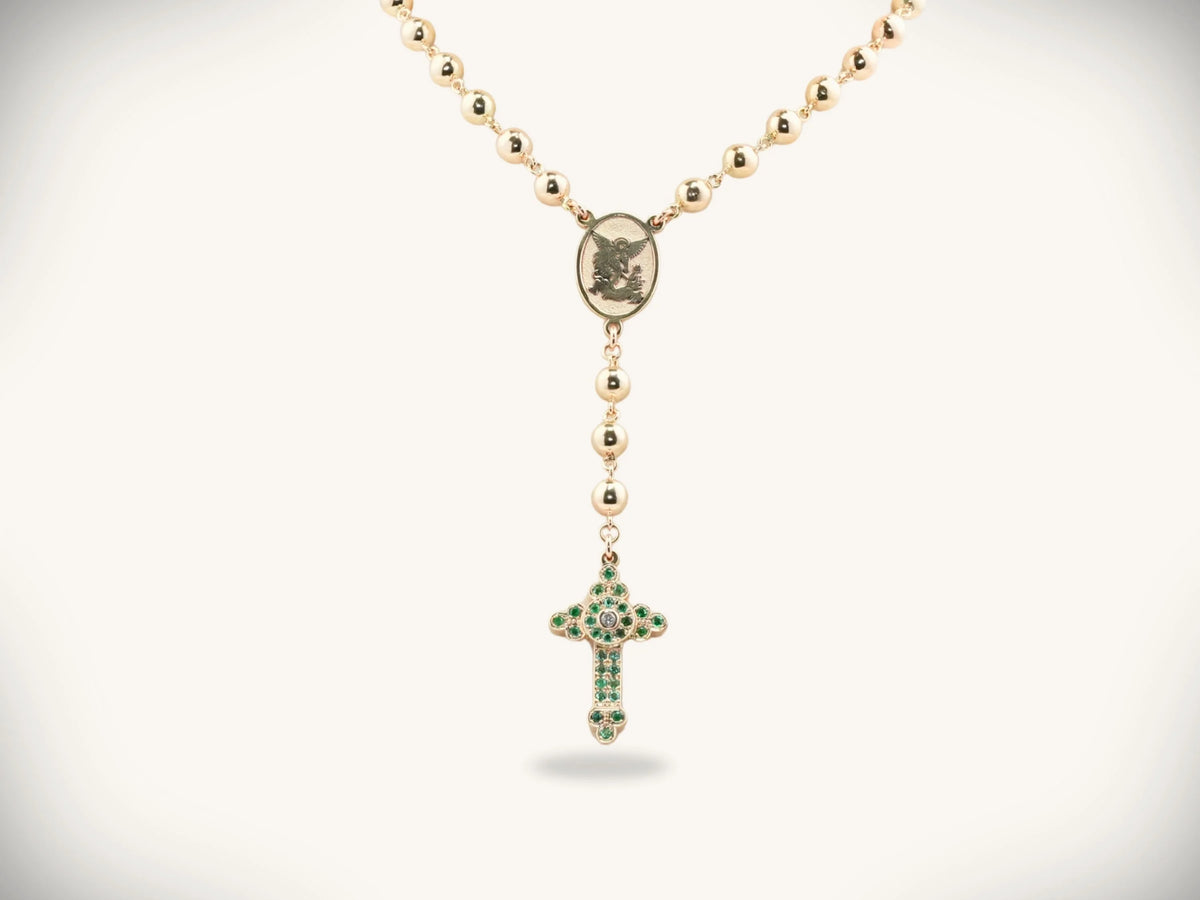 Solid gold rosary necklace with emerald and diamond cross medallion