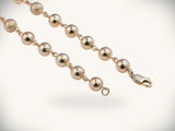 Solid gold rosary necklace with emerald diamond cross and polished beads