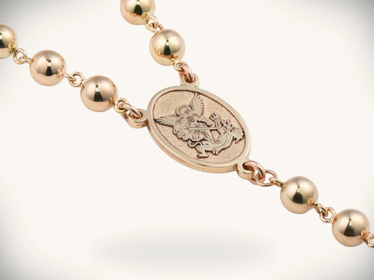 Solid gold rosary necklace with angelic medallion and emerald diamond cross