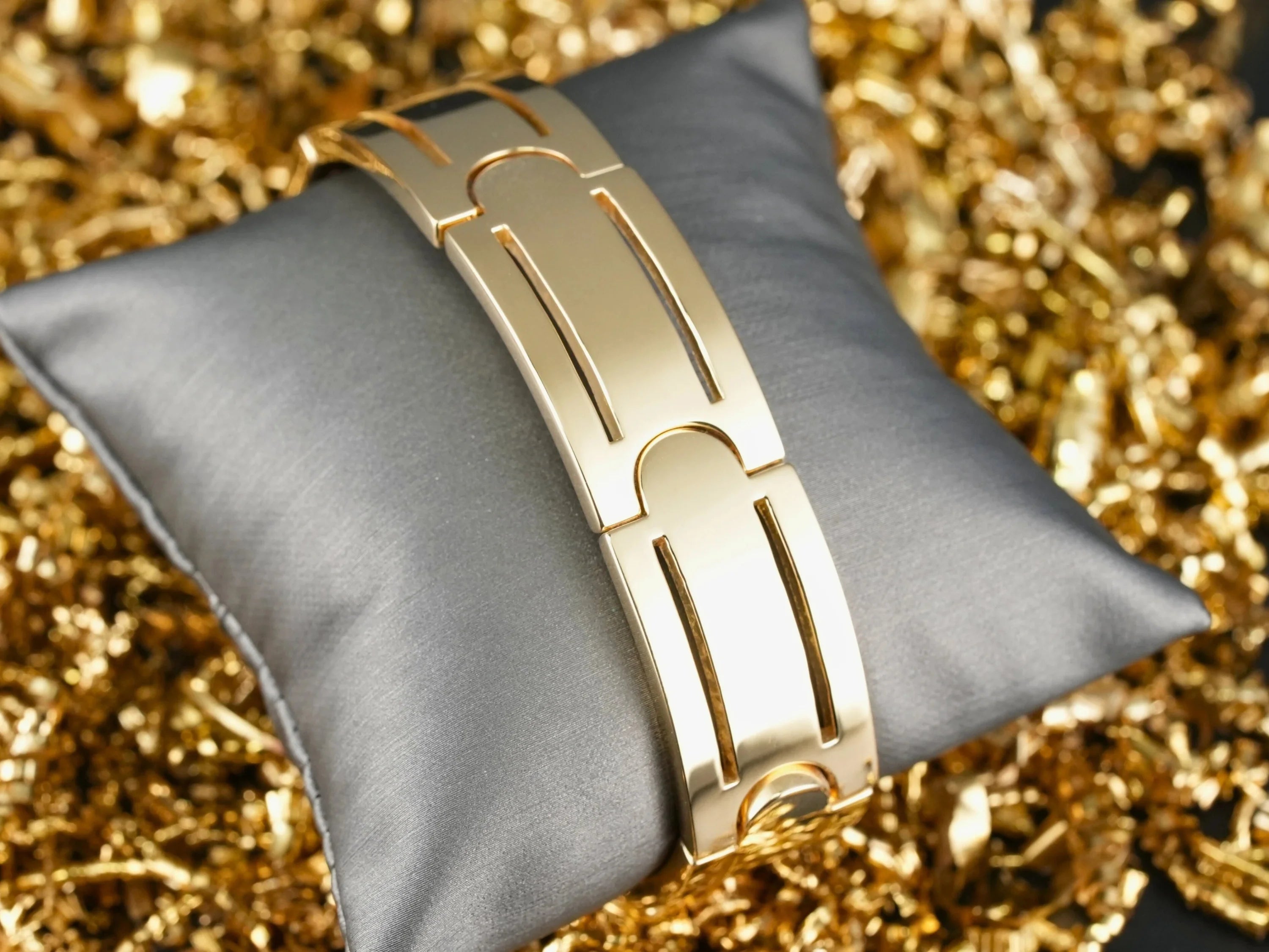 Polished gold-toned Sovereign Bracelet with distinctive link design and art gold signature