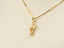 Gold necklace with a sparkling flip flop pendant adorned with clear stones, part of Art Gold Jewelry