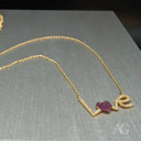Sparkling love necklace in 18k gold with heart ruby and diamond letters pendant
