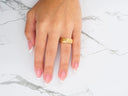 Stellar Strands gold wedding band with sleek gold lines on French manicure finger