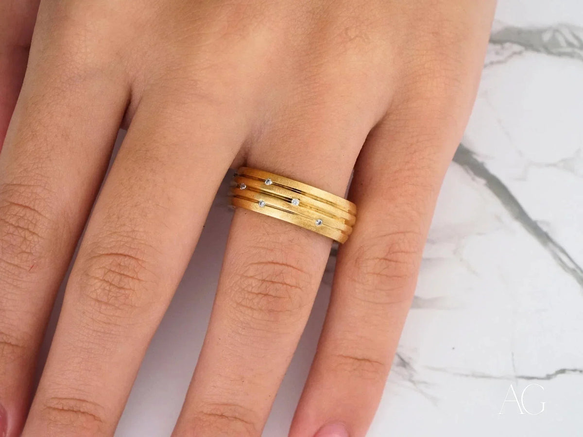 Stellar Strands gold wedding band with sleek gold lines and diamonds