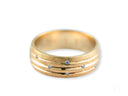 Stellar Strands gold wedding band with sleek gold lines and seven diamonds
