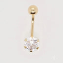 Stunning 18k gold bellybutton piercing with curved barbell and CZ gem