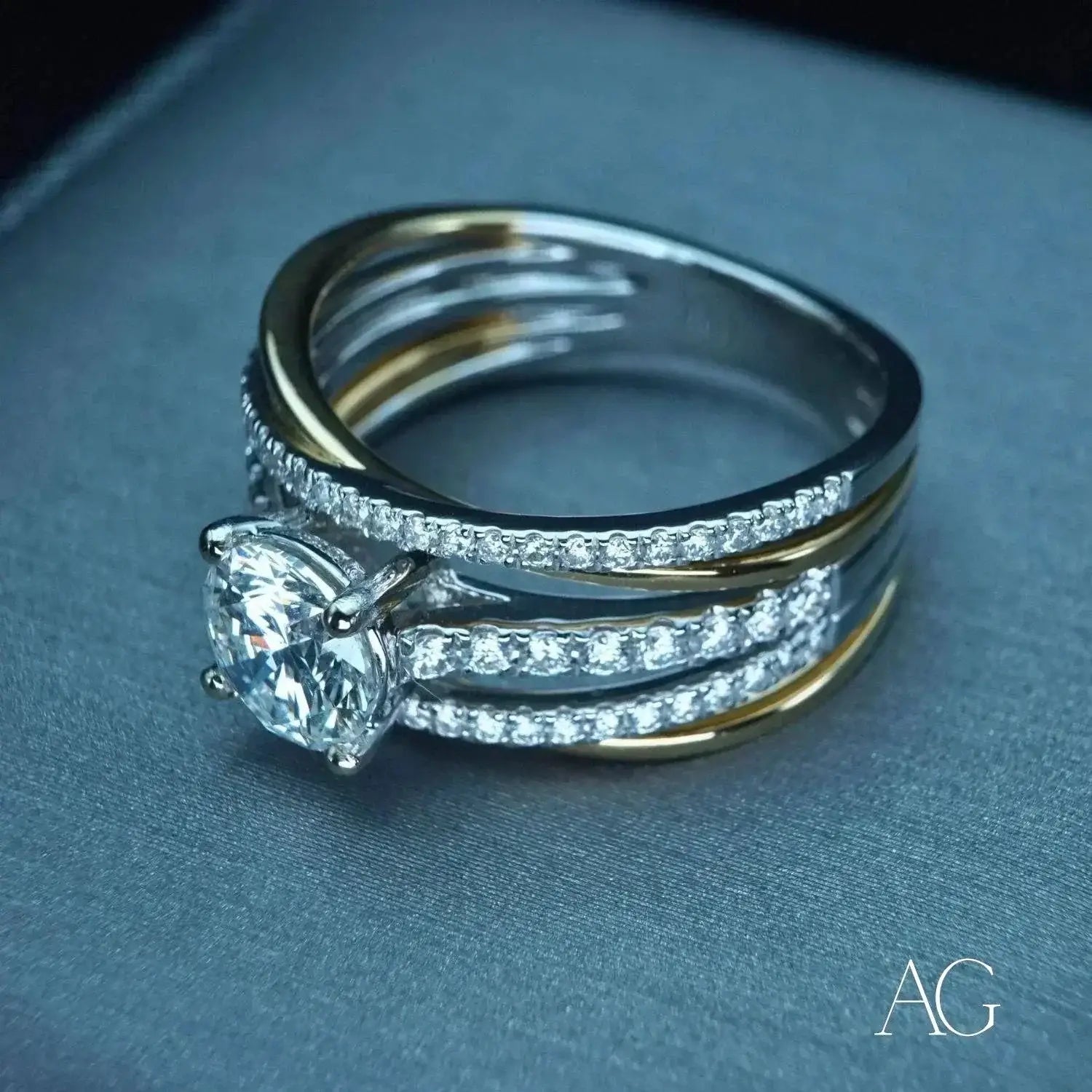 A collection of gold jewelry featuring 18k gold wedding bands with various designs including a pink opal ring.