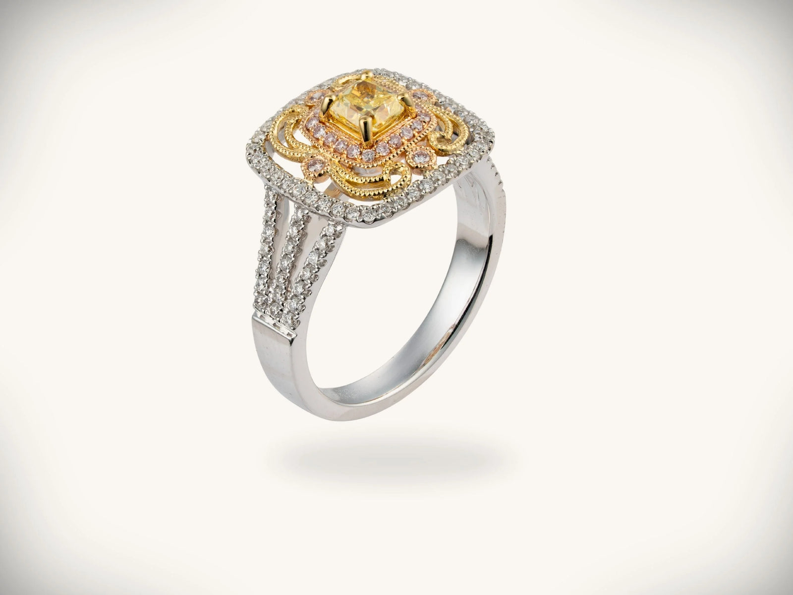 Sunburst halo gold jewelry with central yellow diamond and filigree