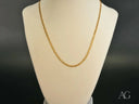 Supreme Elegance 18K gold Cuban chain necklace on cream bust