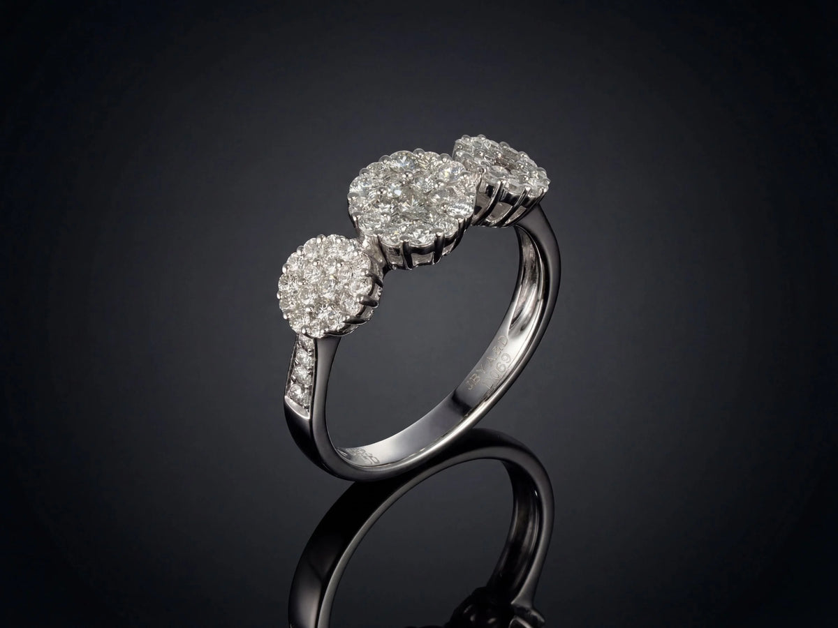 Three-stone diamond cluster ring, angled side view highlighting triple cluster design and diamond band
