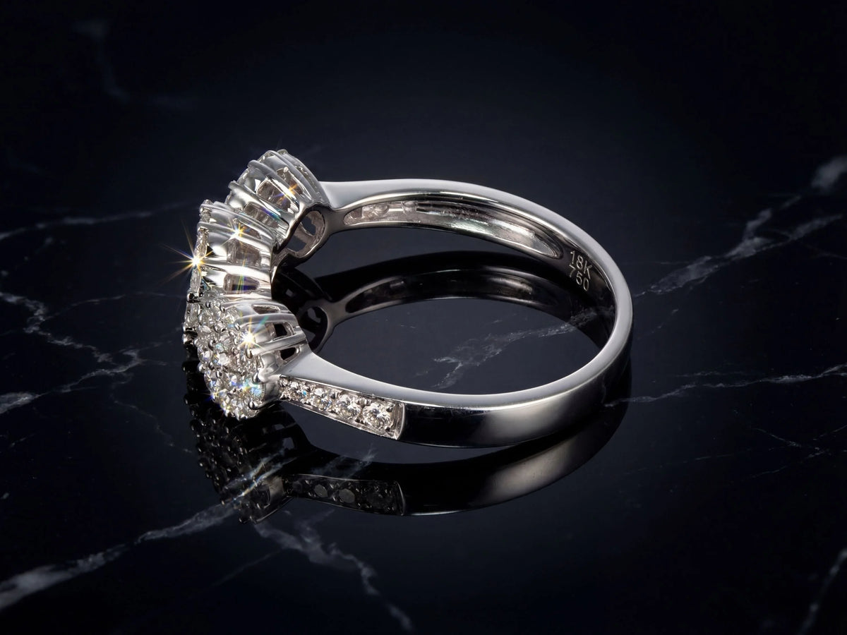 Three-stone diamond cluster ring, side view showing diamond shoulders and triple cluster setting
