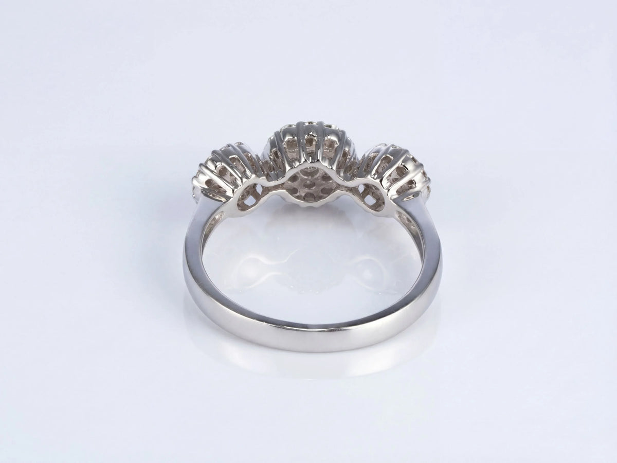 Three-stone diamond cluster ring, underside view showing gallery and openwork cluster settings