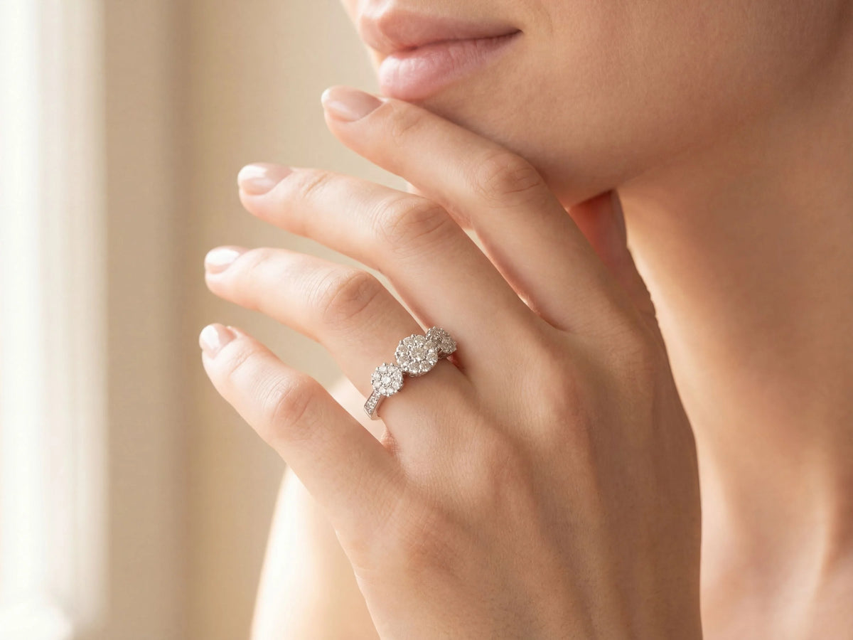 Three-stone diamond cluster ring with triple diamond clusters and diamond shoulders, close-up detail