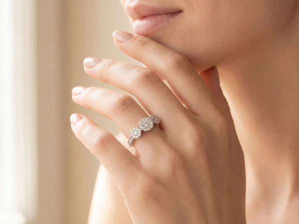 Three-stone diamond cluster ring with triple diamond clusters and diamond shoulders, close-up detail