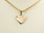 Art gold jewelry featuring a three-tone heart pendant with striped textures