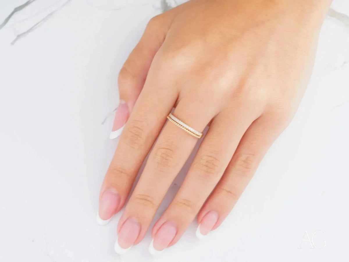 Womans hand with 18k yellow gold CZ half-round ring, luxurious art gold