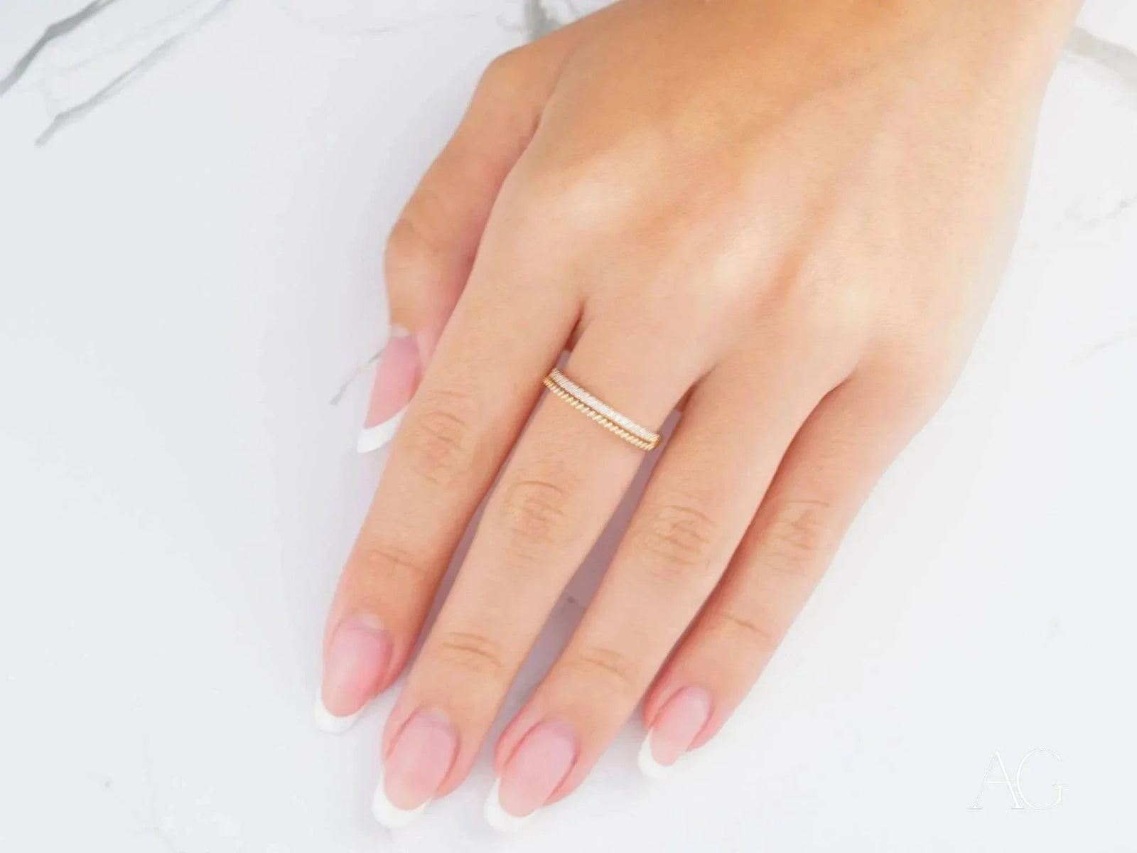 Womans hand with 18k yellow gold CZ half-round ring, luxurious art gold