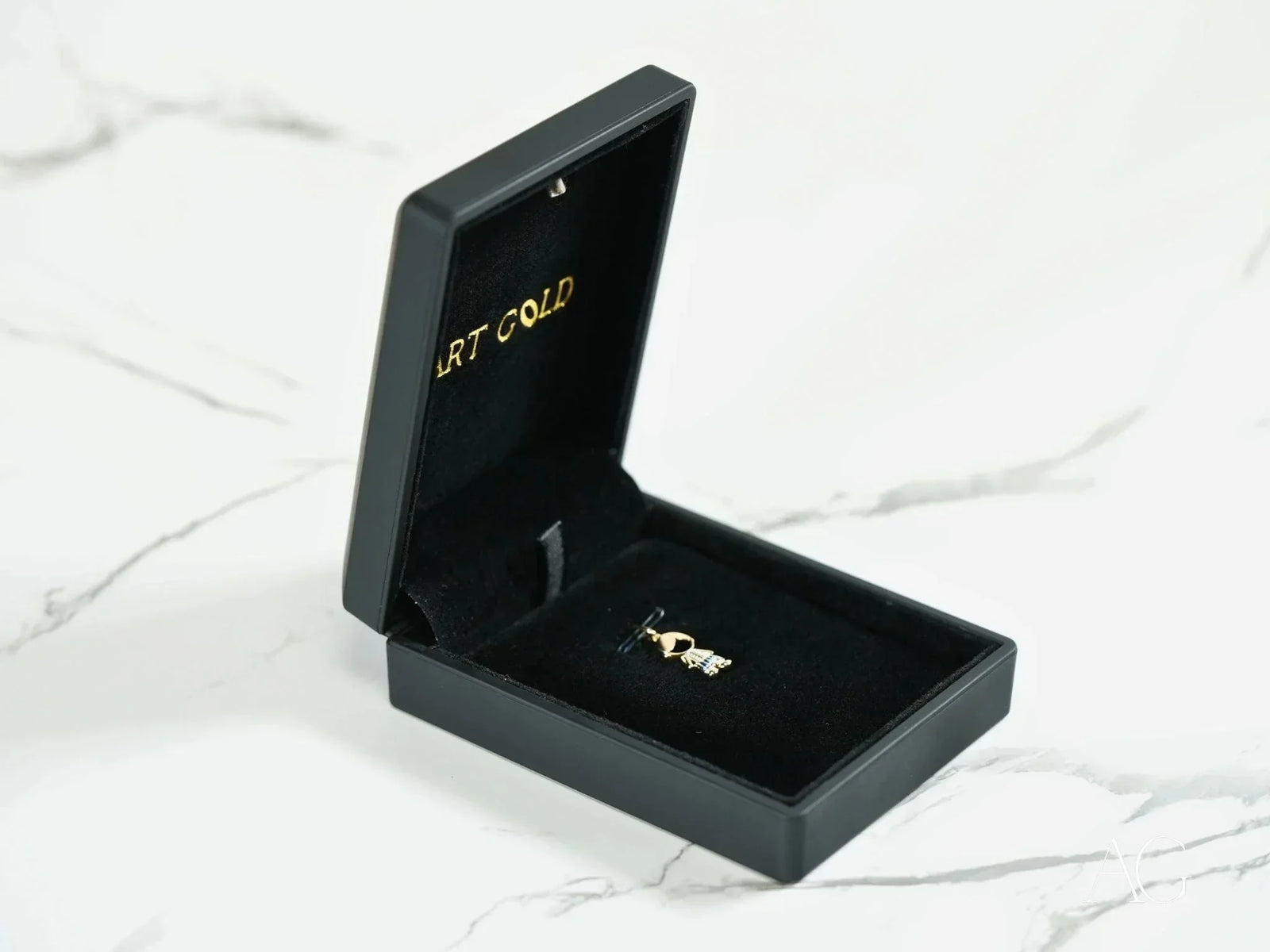 Black velvet box with 18k solid gold timeless charm pendant ring inside