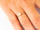 18k yellow gold solitaire ring with round cubic zirconia, side view showing prong setting