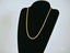 Solid 14k Gold Rope Chain Necklace with Lobster Lock displayed on black stand